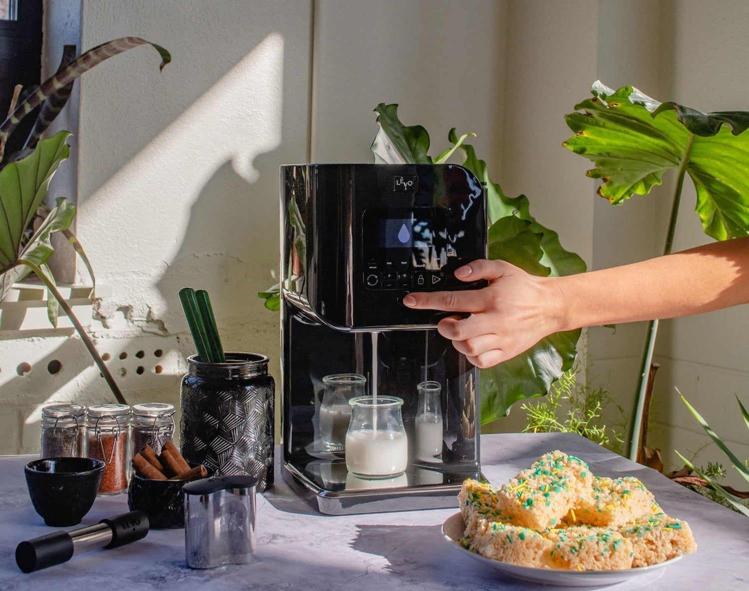 Image of a person dispensing milk from the LĒVO II