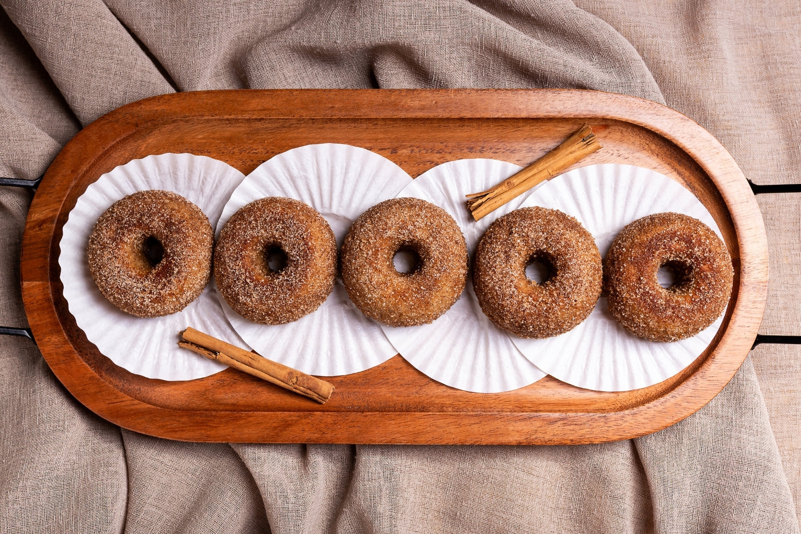 Cinnamon and hemp infused donuts placed on a wood serving plate