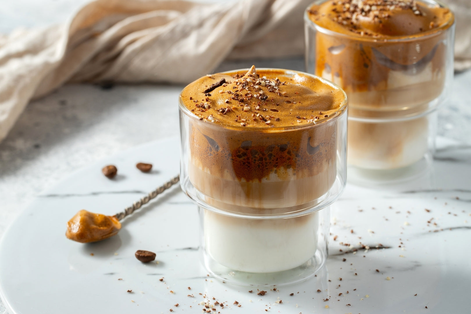 Two cups of whipped infused coffee made using flower infused with the LĒVO.