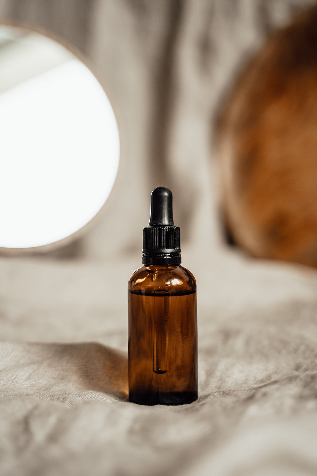 Image of DIY hair growth oil in a bottle by LĒVO.