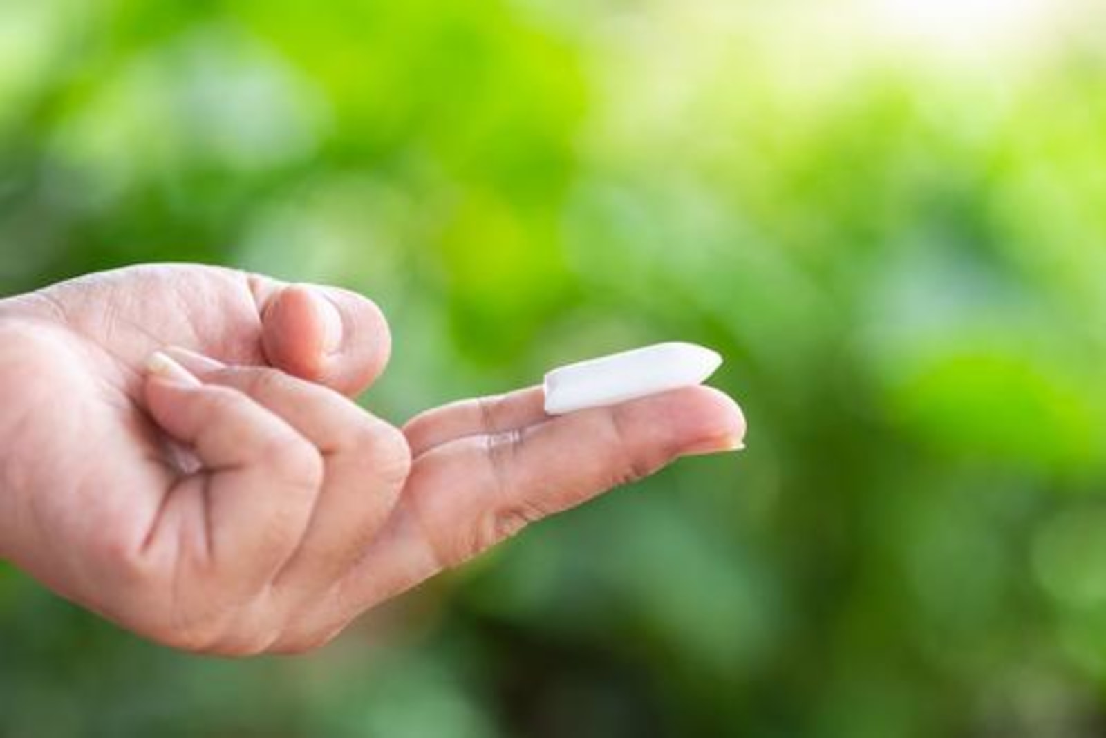 Image of a person holding a suppository. Learn how to make suppositories with LĒVO.