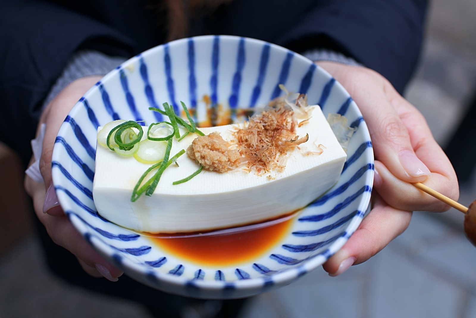 Bowl with infused marinade for tofu recipe inside by LĒVO.