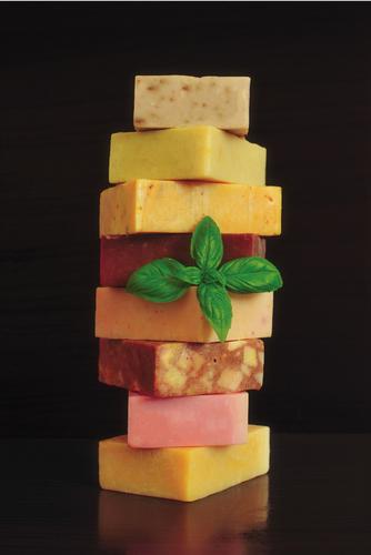 Stacked colorful suncreen lotion bars made using LEVO's sunscreen lotion bars recipe.