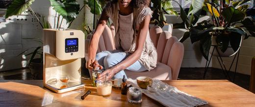 Image of a woman sitting next to the LĒVO II. What is infusion? Find out with LĒVO.