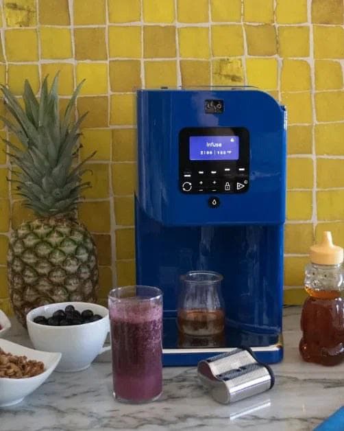 A LĒVO II+ with fresh smoothies and ingredients