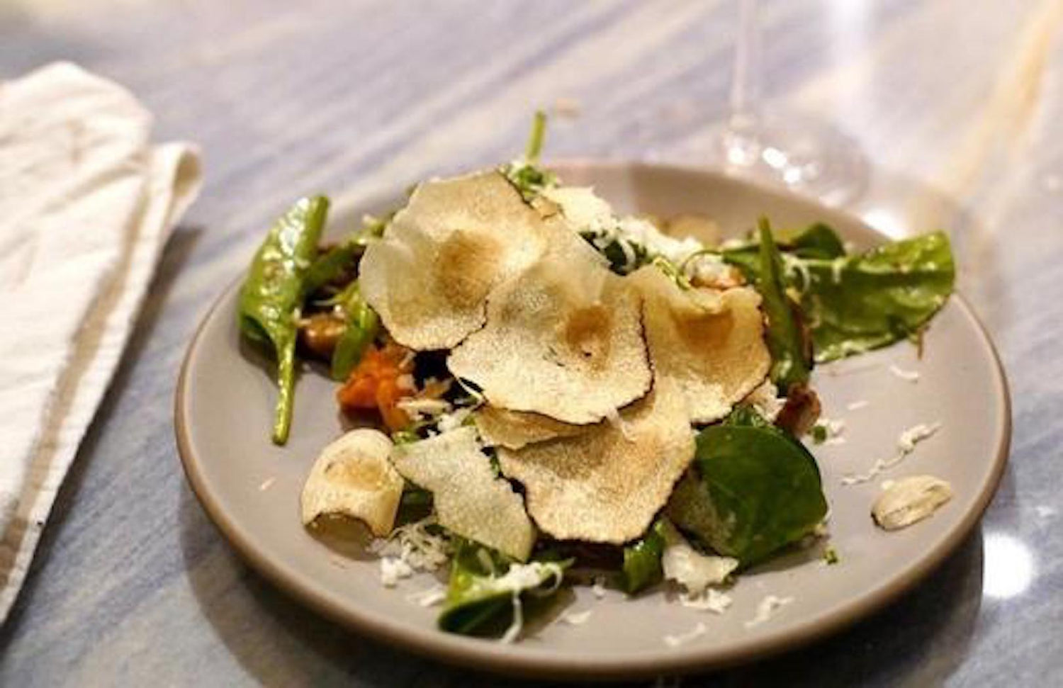 Mushroom salad on a plate, made with LĒVO's wild mushroom salad recipe.