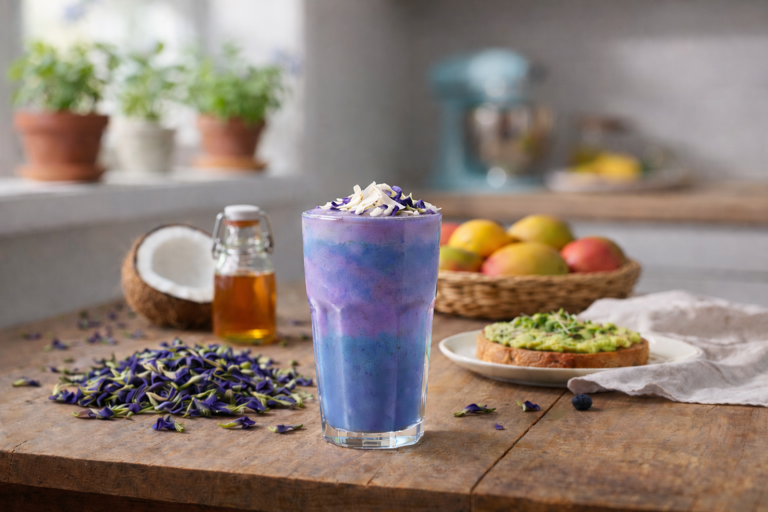Blue butterfly pea flower smoothie on a wooden counter with LEVO infused honey.