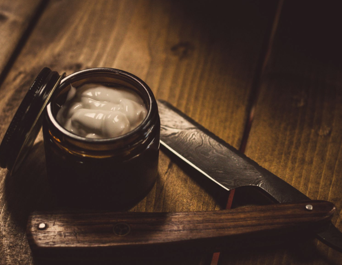 Image of a LEVO made DIY aftershave balm in a reusable container on a wooden table.