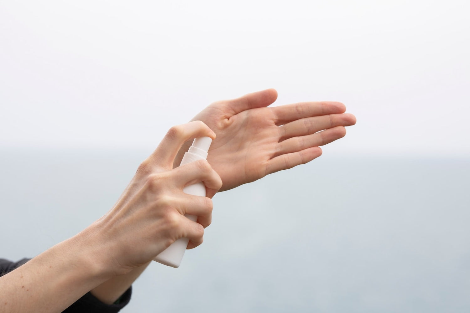 Woman putting hand sanitizer onto her hand after following LĒVO's DIY natural hand sanitizer recipe.