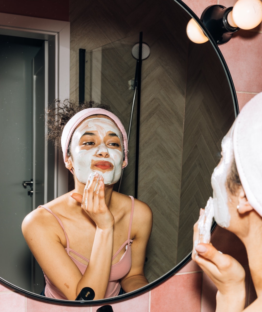 Image of woman applying a DIY skincare routine to her face. LEVO. 