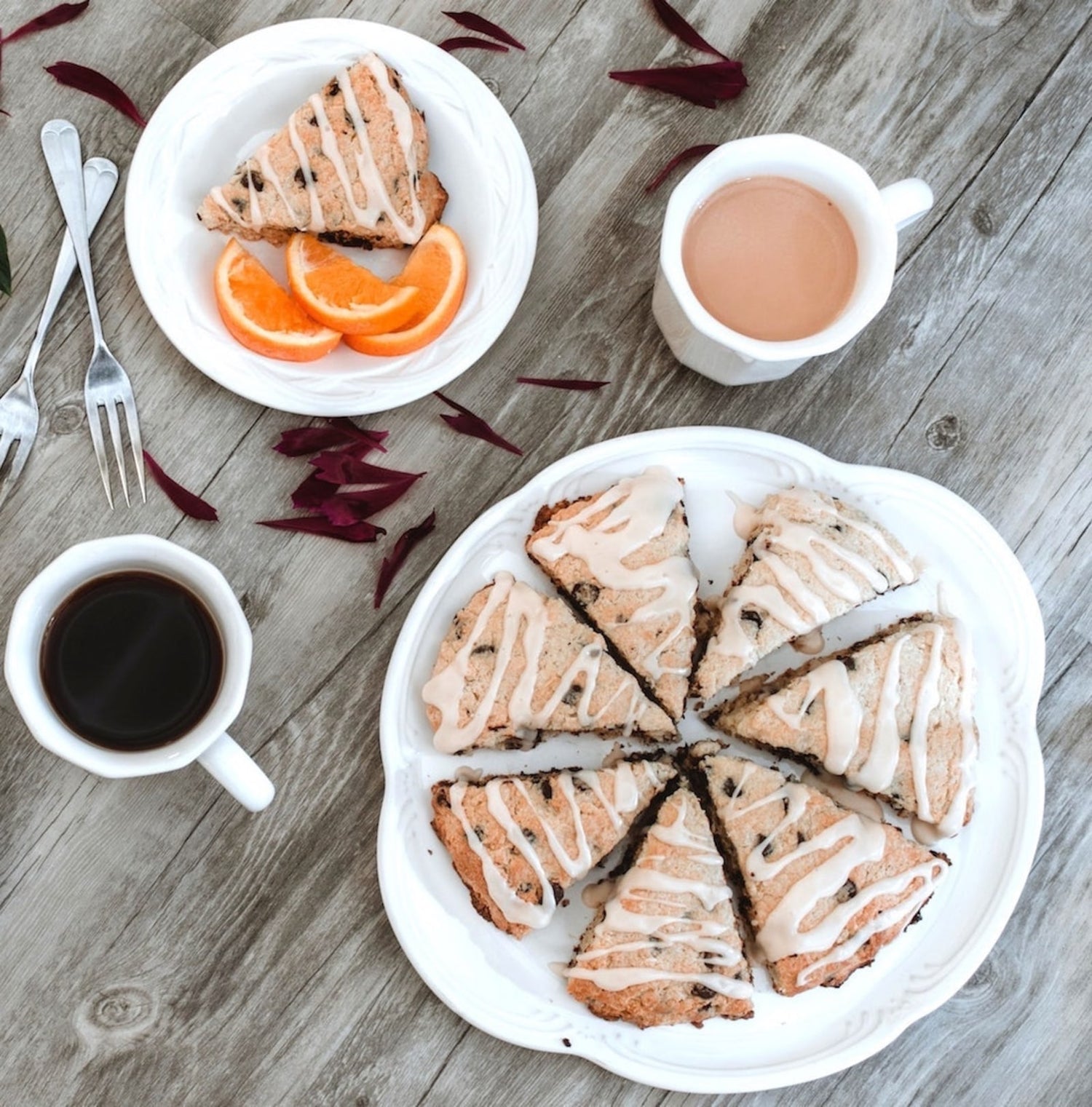 Image of early grey tea scones on a table next to two cups of earl grey tea.