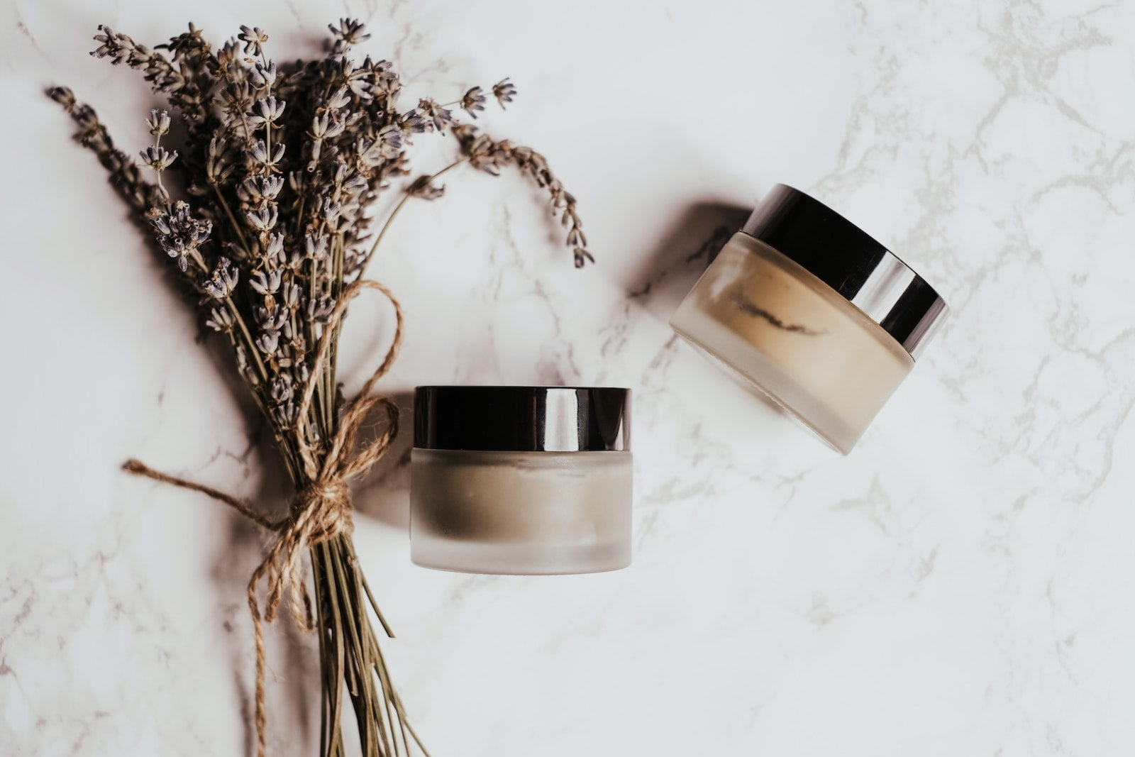 Image of two containers of DIY moisturizer. Make your own by following our moisturizer recipe.