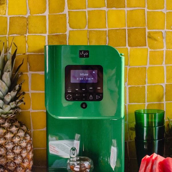 LĒVO II+ in Garden Green on a kitchen counter with a recipe book #Color_Garden Green