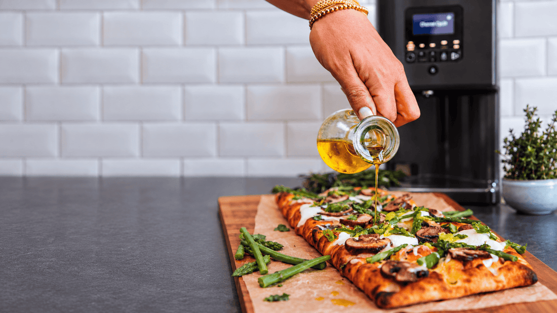 Infused oil poured over flatbread next to a LĒVO II+