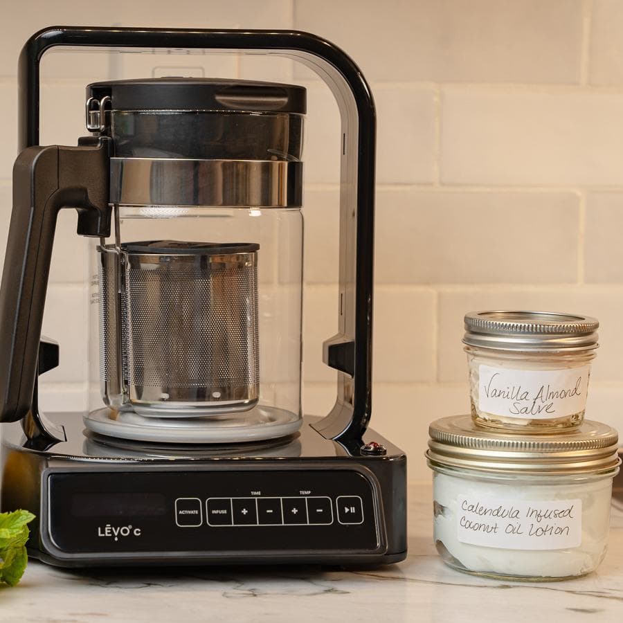 LĒVO C with jars of homemade vanilla almond salve and calendula coconut oil lotion